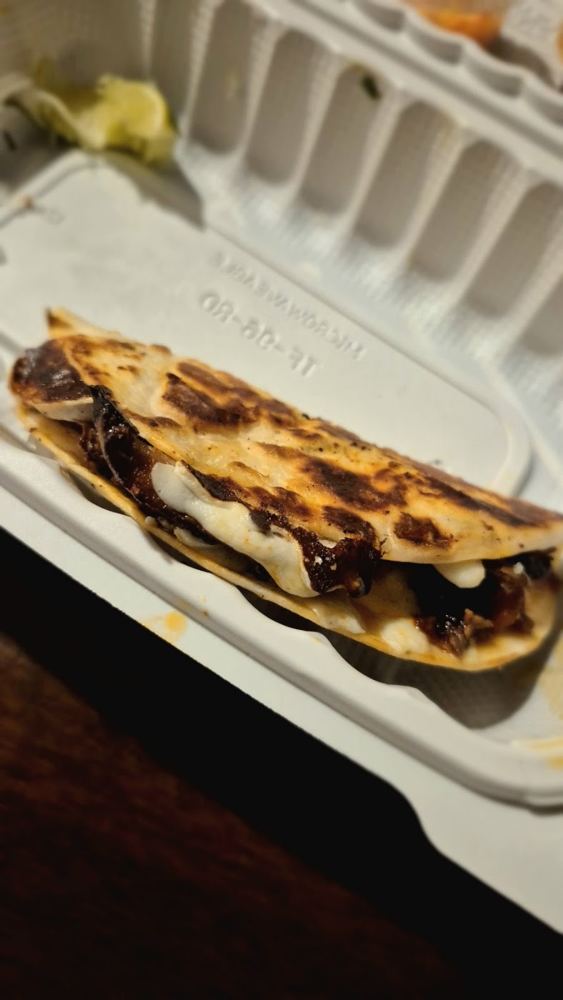 Gringa with al pastor and cheese on a flour tortilla