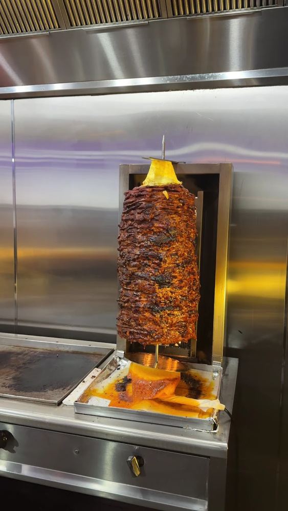 Al pastor trompo turning by the flame